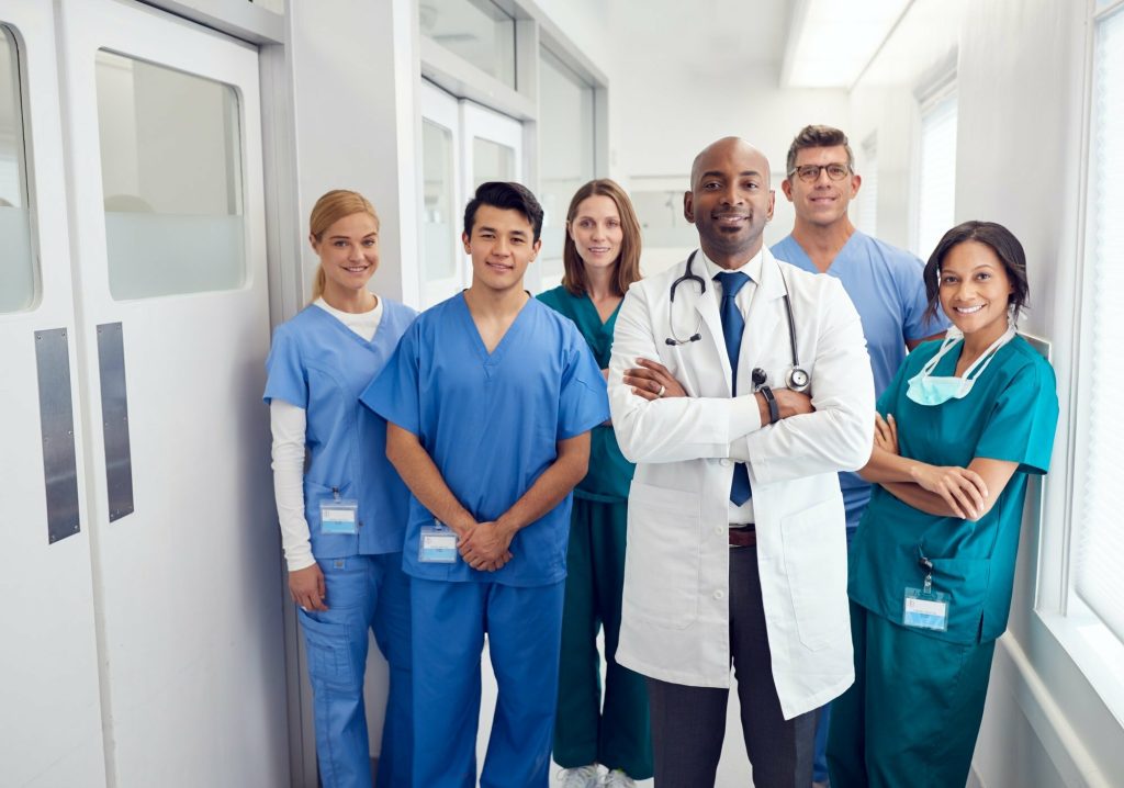 portrait-of-multi-cultural-medical-team-standing-in-hospital-corridor